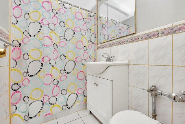 bathroom featuring tile walls, tile patterned flooring, vanity, and toilet