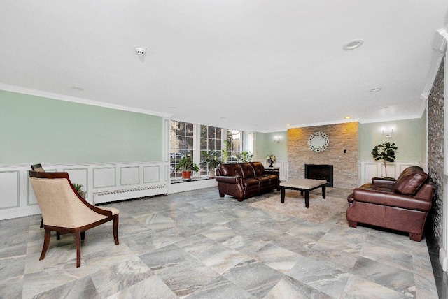 living room featuring a baseboard radiator, a fireplace, and ornamental molding