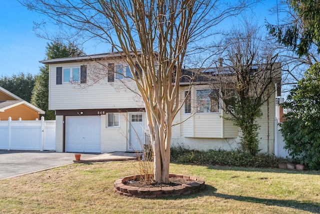 view of front of property featuring a garage and a front yard