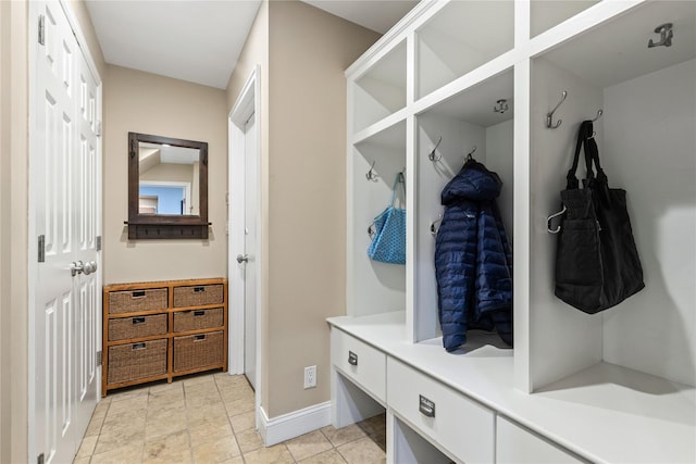 mudroom with baseboards and light tile patterned flooring