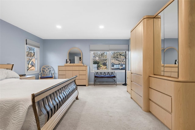 bedroom featuring recessed lighting, light carpet, and baseboards