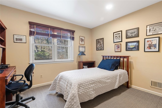 bedroom featuring baseboards, visible vents, and light colored carpet