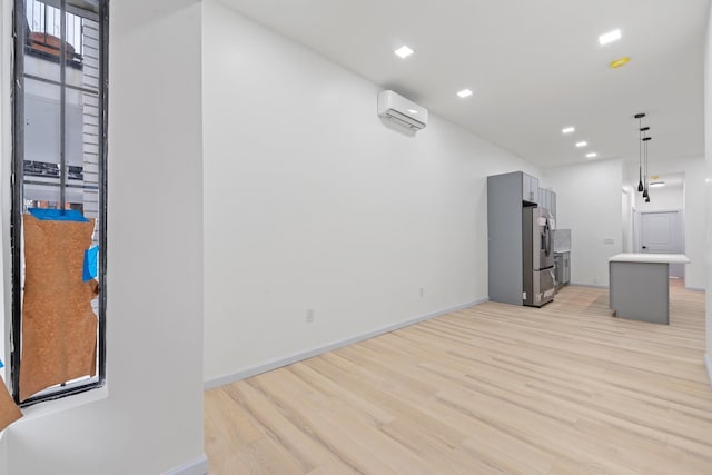 living room featuring light hardwood / wood-style floors and a wall mounted AC