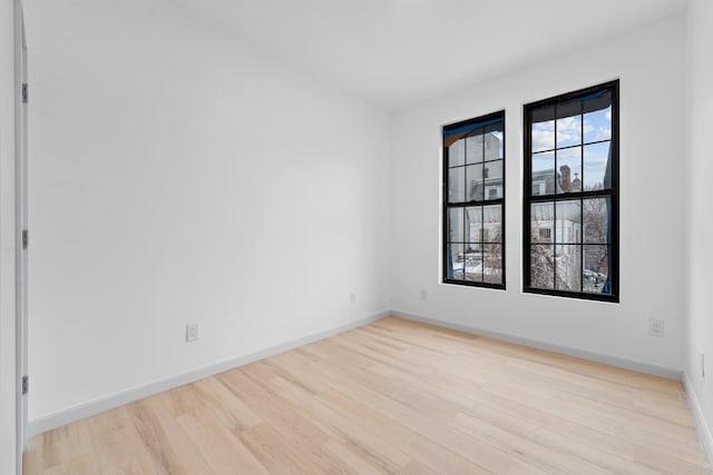 empty room with light hardwood / wood-style floors