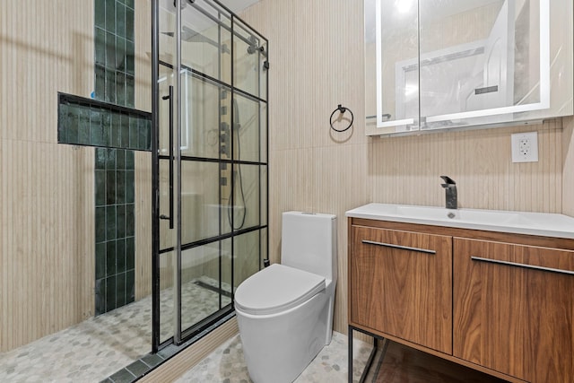 bathroom with tile patterned flooring, vanity, a shower with shower door, and toilet