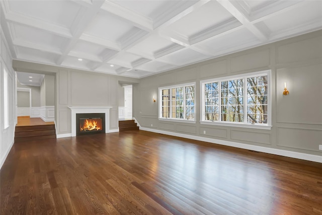 unfurnished living room with dark wood-type flooring, coffered ceiling, and beam ceiling