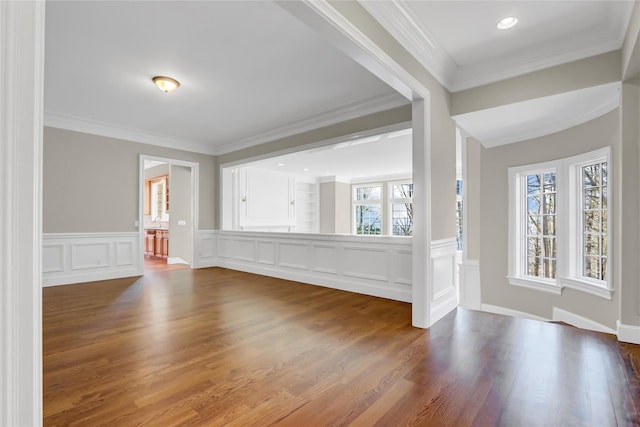 unfurnished living room with crown molding, wood-type flooring, and a healthy amount of sunlight