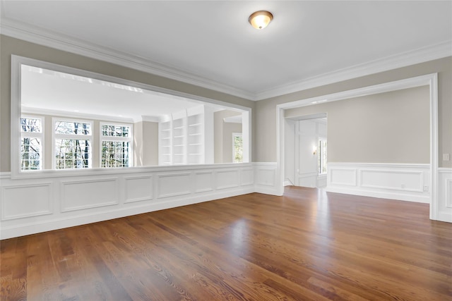 unfurnished room with ornamental molding and wood-type flooring