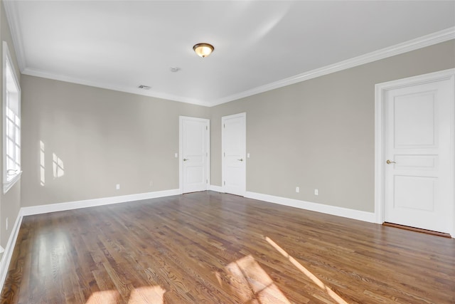 spare room with dark hardwood / wood-style flooring and ornamental molding