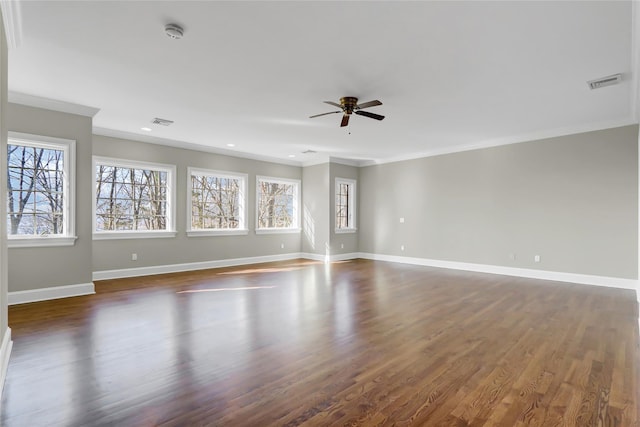 empty room with crown molding, ceiling fan, and dark hardwood / wood-style floors