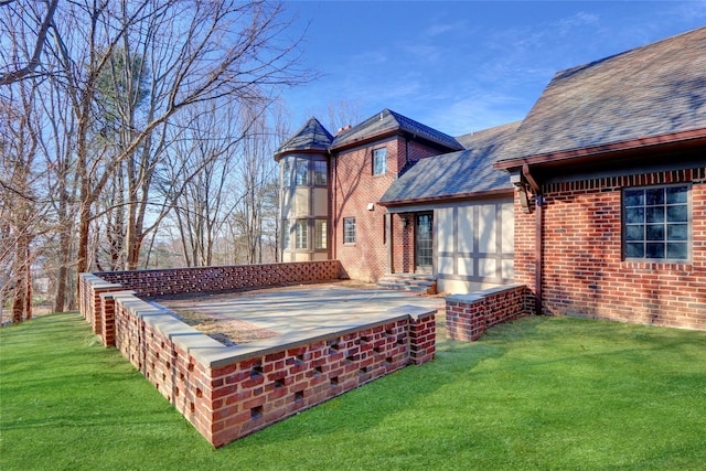 rear view of house with a patio and a lawn