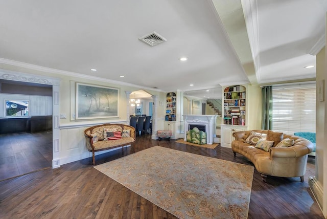 living room with ornamental molding, plenty of natural light, dark hardwood / wood-style floors, and beam ceiling