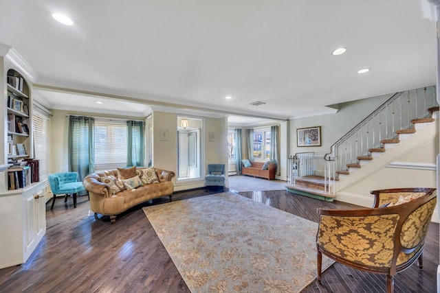 living room featuring dark wood-type flooring and ornamental molding
