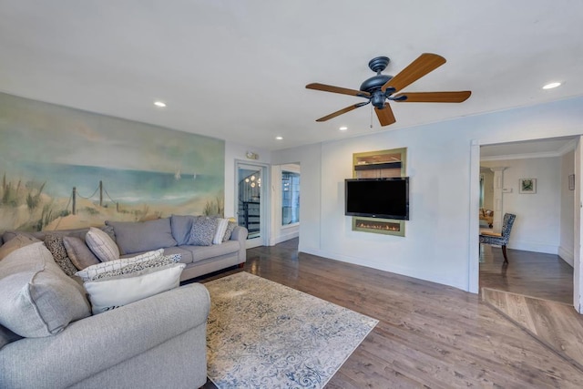 living room with crown molding, hardwood / wood-style flooring, and ceiling fan