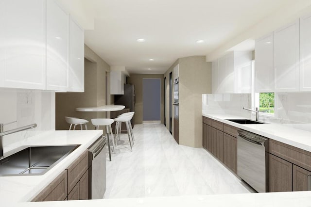 kitchen featuring appliances with stainless steel finishes, sink, and white cabinets