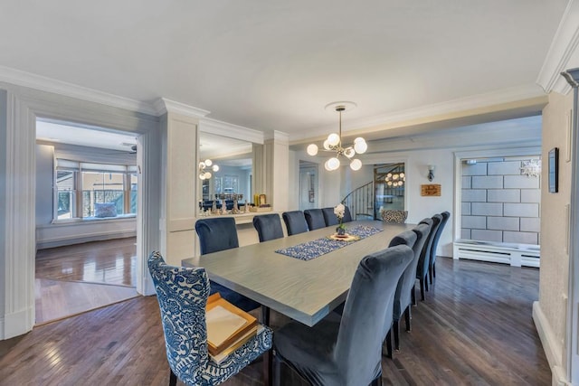 dining room featuring dark wood-type flooring, ornamental molding, and a chandelier
