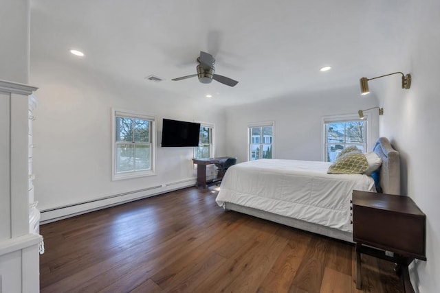 bedroom with ceiling fan, a baseboard radiator, dark hardwood / wood-style floors, and multiple windows