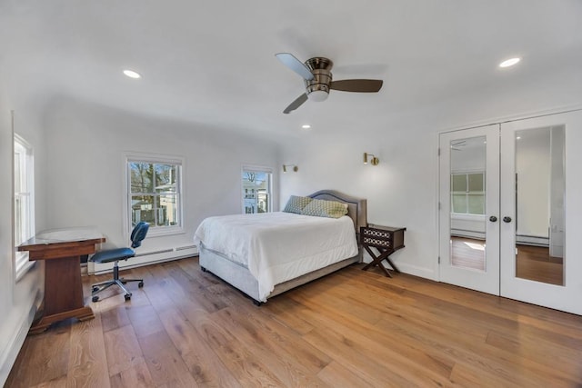 bedroom with light hardwood / wood-style floors, french doors, ceiling fan, and baseboard heating
