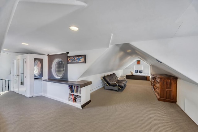 living area with lofted ceiling and carpet