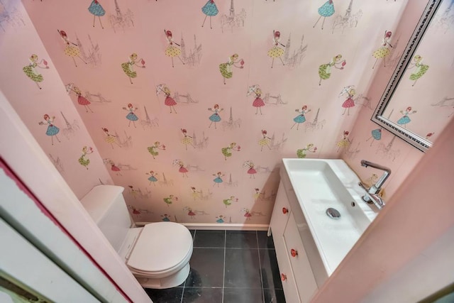 bathroom featuring tile patterned flooring, vanity, and toilet