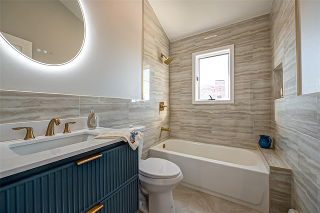 full bathroom with toilet, tile patterned floors, vanity, tile walls, and tiled shower / bath