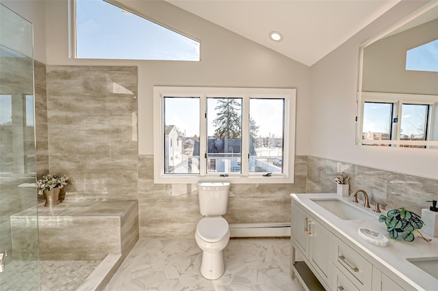 bathroom with vaulted ceiling, tile walls, toilet, vanity, and baseboard heating