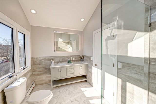 bathroom featuring toilet, vanity, tile walls, a baseboard heating unit, and lofted ceiling