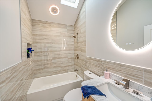 full bathroom featuring tile walls, lofted ceiling, tiled shower / bath combo, and toilet