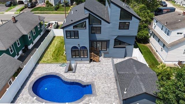 2726 Clarendon Ave, Bellmore, NY 11710 - back of house with a fenced backyard, a patio, and a residential view