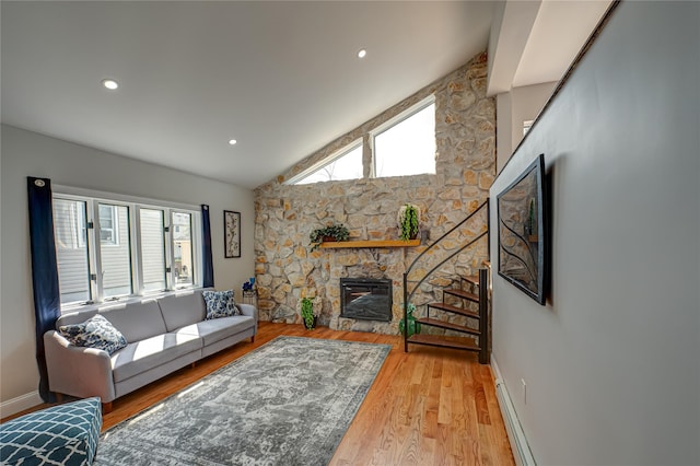 2726 Clarendon Ave, Bellmore, NY 11710 - living room with a fireplace, wood finished floors, vaulted ceiling, and recessed lighting