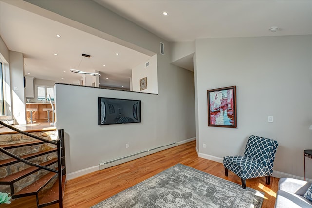 2726 Clarendon Ave, Bellmore, NY 11710 - living area featuring a baseboard heating unit, wood finished floors, and recessed lighting