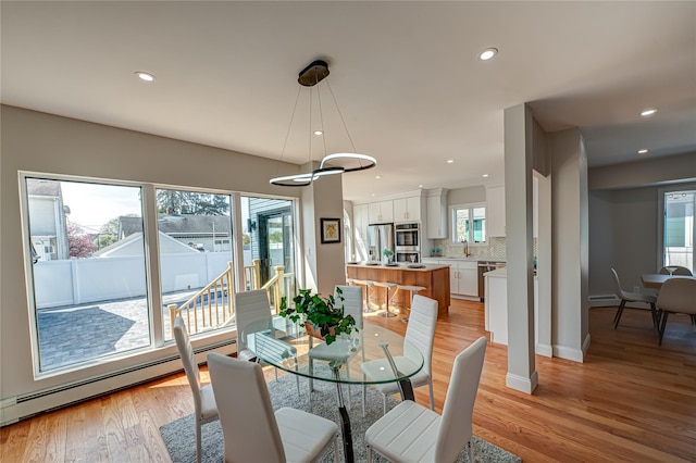 2726 Clarendon Ave, Bellmore, NY 11710 - dining area with baseboard heating, plenty of natural light, light wood finished floors, and recessed lighting