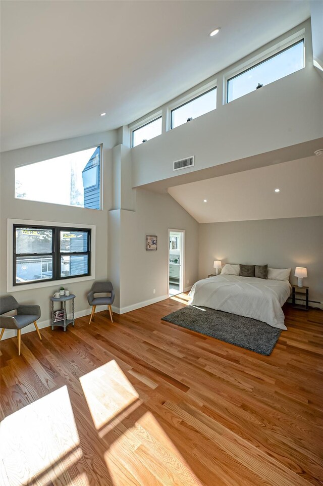2726 Clarendon Ave, Bellmore, NY 11710 - bedroom with wood finished floors, high vaulted ceiling, and recessed lighting