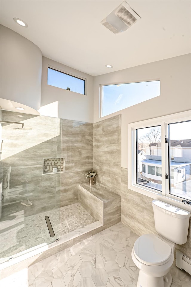 2726 Clarendon Ave, Bellmore, NY 11710 - bathroom with healthy amount of natural light, a baseboard heating unit, tile walls, recessed lighting, and wainscoting