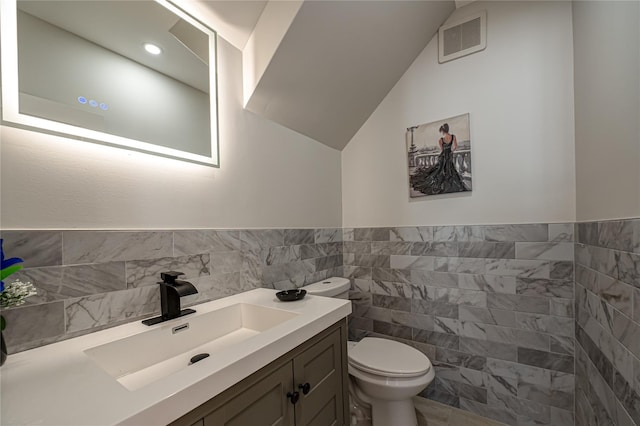 2726 Clarendon Ave, Bellmore, NY 11710 - bathroom featuring tile walls, vanity, a wainscoted wall, and lofted ceiling