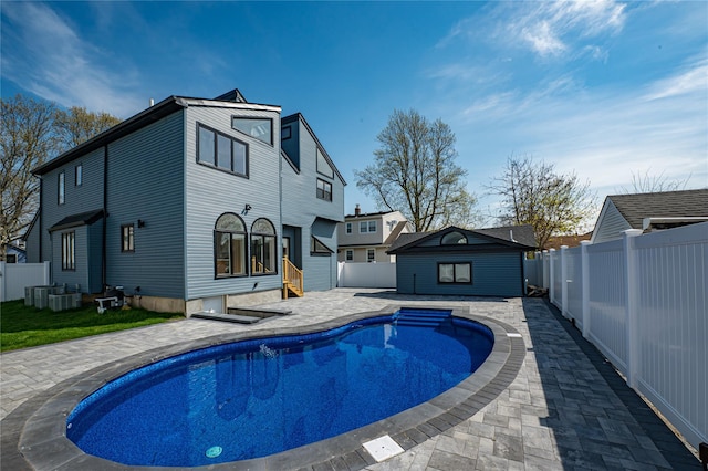 2726 Clarendon Ave, Bellmore, NY 11710 - rear view of property with an outdoor structure, a fenced backyard, and a patio area
