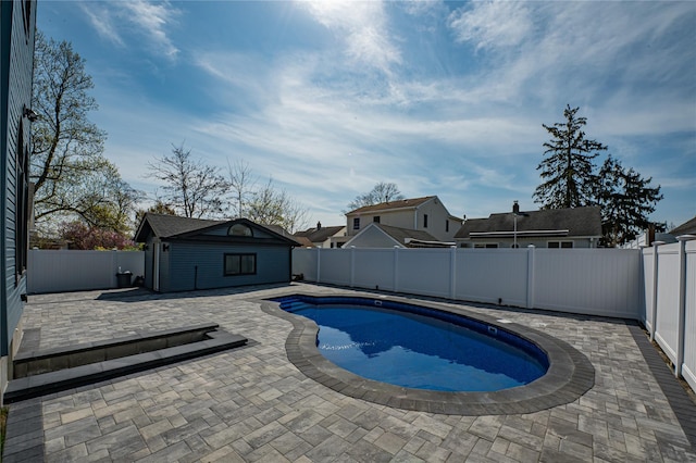 2726 Clarendon Ave, Bellmore, NY 11710 - view of swimming pool featuring an outdoor structure, a fenced backyard, and a patio