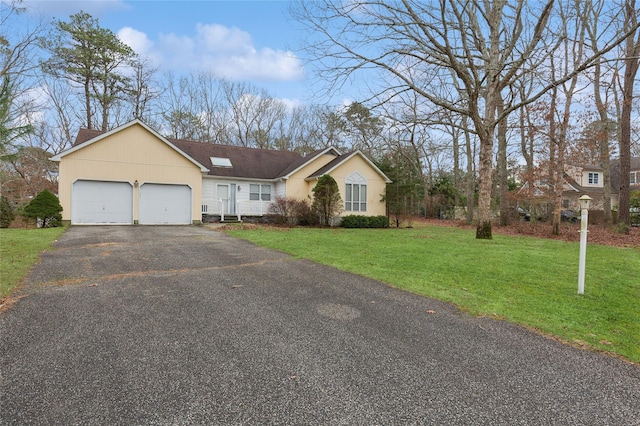 single story home with a front yard and a garage