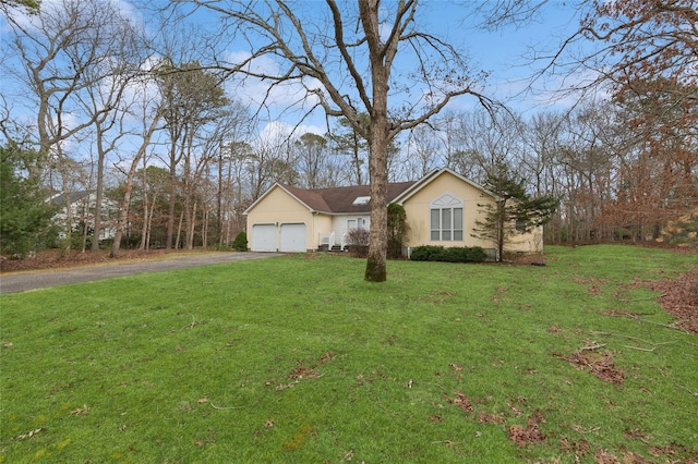 view of front of home with a front yard and a garage