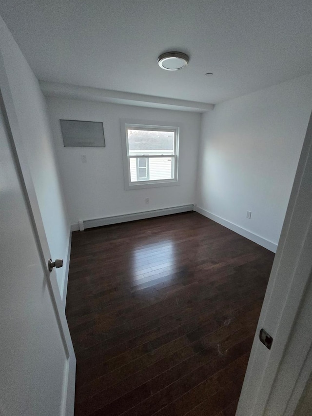 unfurnished room featuring dark hardwood / wood-style flooring and a baseboard radiator