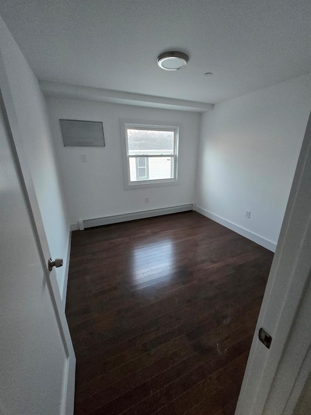 531 Bch 72nd St, Arverne, NY 11692 - empty room with a baseboard heating unit and dark wood-style floors