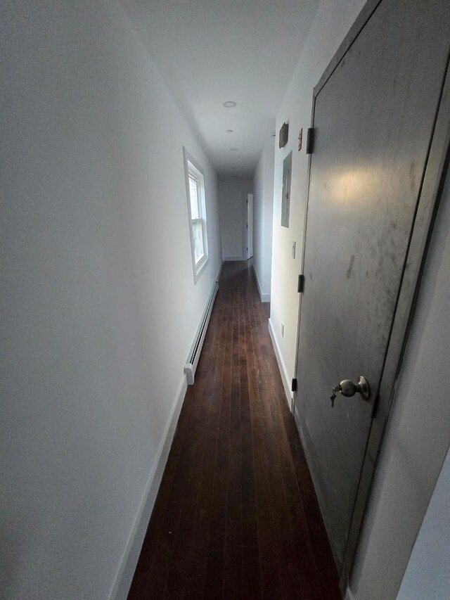 531 Bch 72nd St, Arverne, NY 11692 - corridor featuring a baseboard heating unit and dark wood-style floors