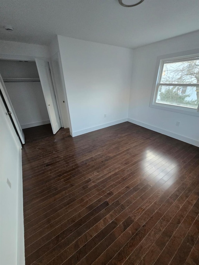 spare room with dark hardwood / wood-style flooring