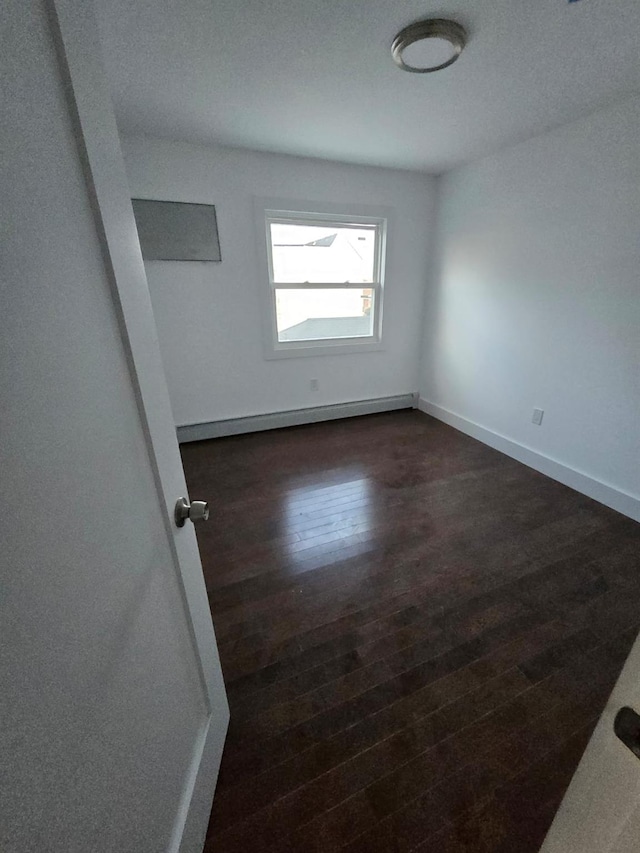 spare room with dark wood-type flooring