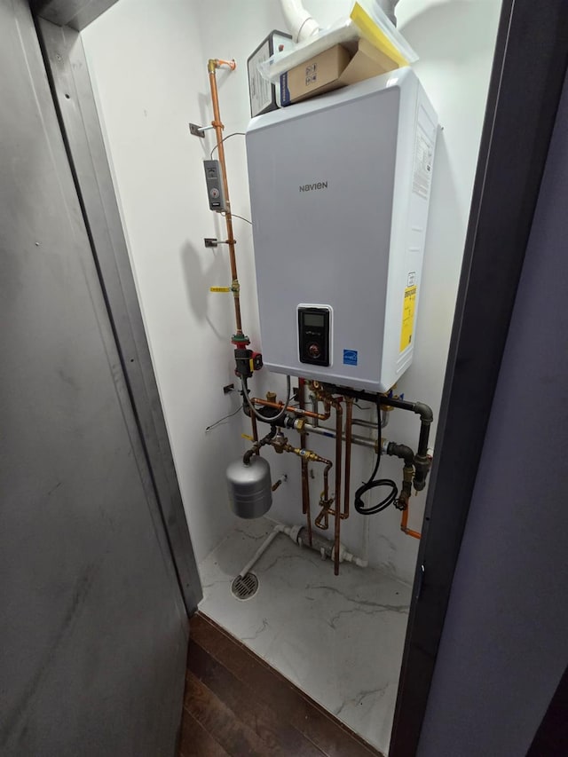 utility room with tankless water heater