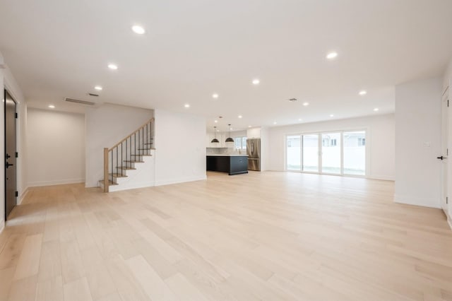 unfurnished living room featuring light hardwood / wood-style floors