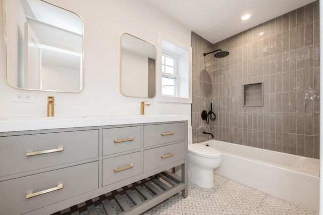 full bathroom featuring vanity, toilet, and tiled shower / bath