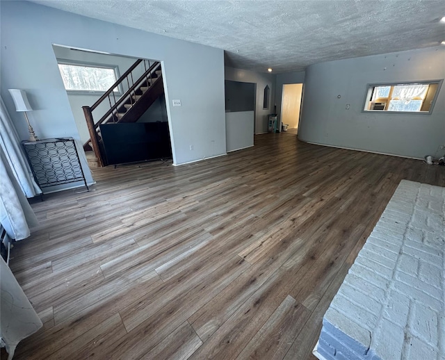 living room featuring wood-type flooring and a textured ceiling