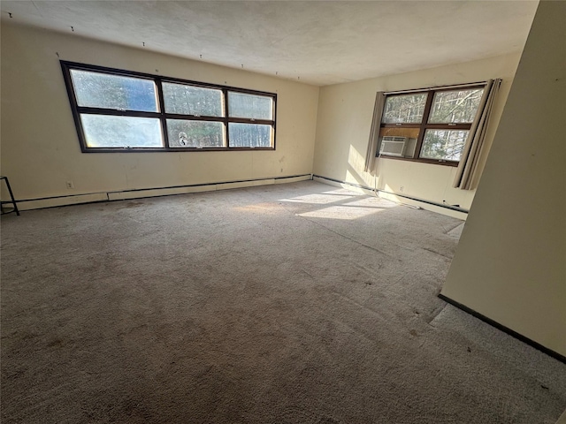 carpeted spare room with baseboard heating and cooling unit