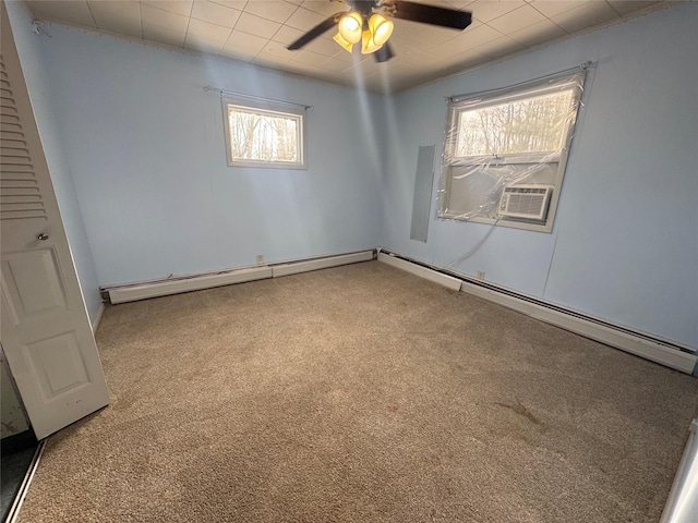 carpeted spare room with ceiling fan and a baseboard heating unit